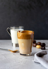 Trendy Korean dalgona coffee. Milk with ice and foam of coffee. Vertical orientation, copy space