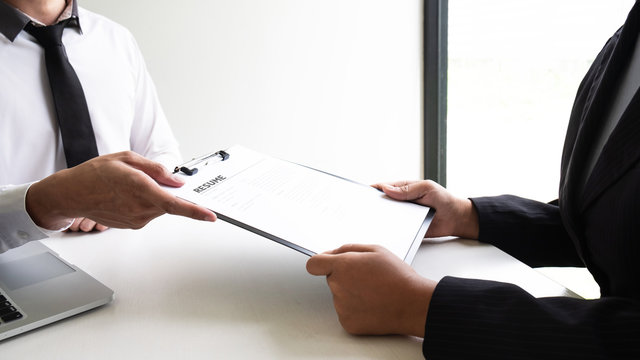 Job applicant is sending a resume to interview employee in the office.