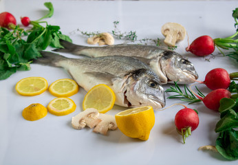 orata fresh fish ready to cook with vegetables and herbs as ingredient