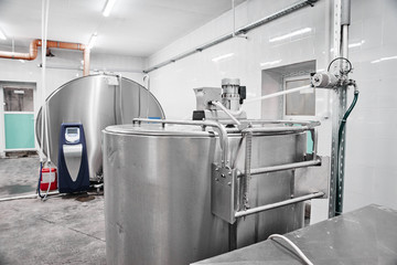 Automated cow farm, milk tanks. Milking machine, modern production technology at the factory