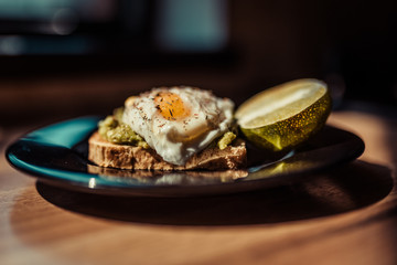 Poached egg with avocado cream on toast