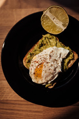 Poached egg with avocado cream on toast