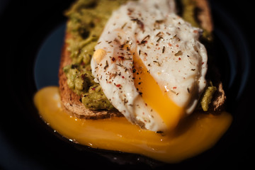 Poached egg with avocado cream on toast
