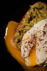Poached egg with avocado cream on toast