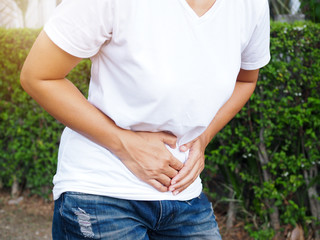 Asian women suffering with severe stomach pain Stomach ache or menstrual pain.