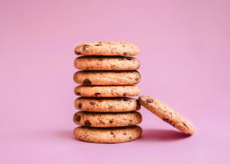 Oatmeal cookie Photo in minimal style Chocolate chip biscuits are lying in a stack on a pink...