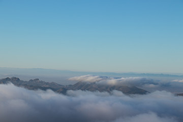 Fototapeta na wymiar Panoramic view of sea of clouds over mountain peaks
