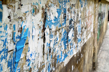 Street wall with old scraps of posters and papers. Photo taken in Beirut, Lebanon