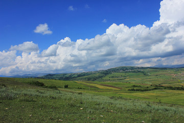 Fototapeta premium Azerbaijan. Cumulus clouds above ground