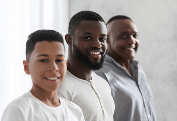Three Male Generations. Smiling African Son, Father And Grandfather Posing To Camera