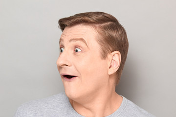 Fototapeta premium Portrait of funny blond mature man with happy overjoyed expression