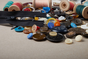 Set of different sewing items - top view of scissors, threads,buttons, sewing needles, fabric and patterns