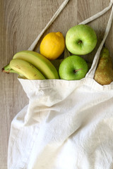 Various fruit in a canvas tote bag. Selective focus.