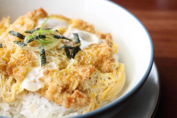 Katsudon is a popular Japanese food, a bowl of rice topped with a deep-fried chicken cutlet, egg, vegetables, and condiments