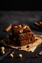 brownie cake wit hazelnut and chocolate on dark grunge table