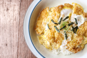 Katsudon is a popular Japanese food, a bowl of rice topped with a deep-fried chicken cutlet, egg, vegetables, and condiments