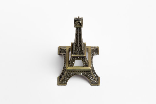 The small Eiffel tower as a souvenir from Paris. Isolated on a white background. High-resolution photo