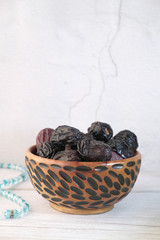 the concept of ramadan, close up of date fruit in a bowl