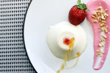 pannacotta with strawberry and almond on top view