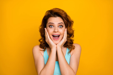 Fototapeta na wymiar Closeup photo of pretty shocked lady open mouth see cool sale prices shopping advert arms on cheeks wear casual turquoise tank-top isolated bright yellow color background
