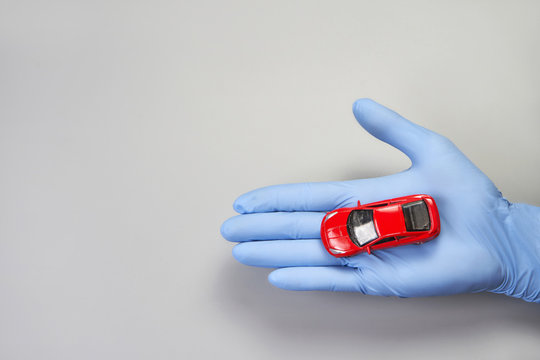 Hand in glove defend toy car. Safety anti virus concept
