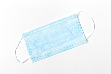Blue disposable medical mask for virus protection, on a white background