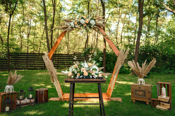 Decoration of the flower arrangement  for the wedding ceremony in the green forest .