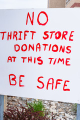 Sign posted outside of thrift store notifying the public that they can't accepted donations during the coronavirus pandemic