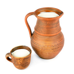 Clay jug and mug with fresh milk isolated on white.