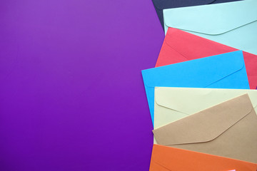 high angle view of colorful envelopes purple background 