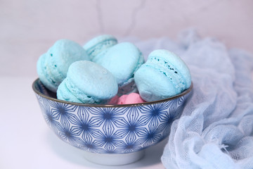 colorful macaroon in a row on pink background .