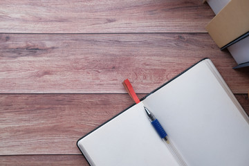 high angle view of notepad with pen on tiles background 