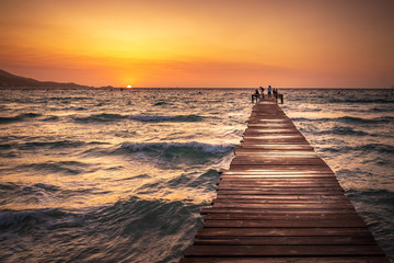 Obraz premium A wooden pier at Playa de Muro beach in Mallorca