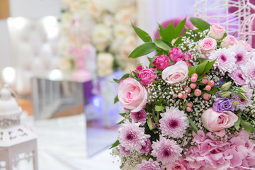 Beautiful bouquet of colored roses wrap bulurred background . Multi-colored flower bouquet .