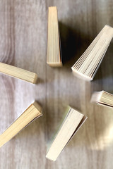 Paperback books on a wooden table. Top view.
