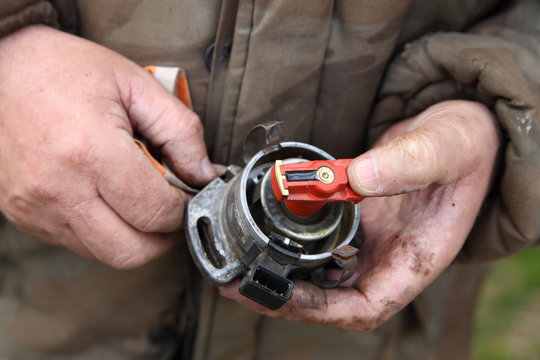 Motor Ignition Distributor With Hall Transducer Without Cap Disassembled From The Engine In The Hands Of A Mechanic Close-up, Car Ignition System Repair