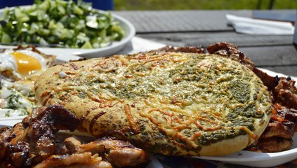 Food at a picnic. Fresh vegetables and grilled meat.
