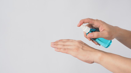 Two Hand and Right hand is holding Alcohol Spray on white background.
