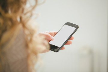 Woman with modern mobile phone in hands