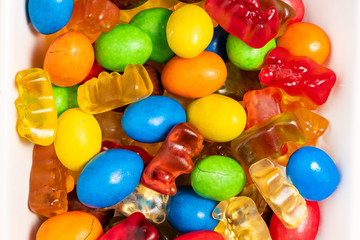 Fototapeta na wymiar Colorful candy and gummi jelly in white bowl