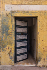 Opened gate of a yellow house, Essaouira