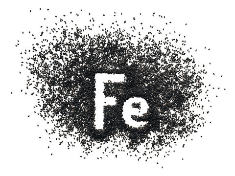 Chemical Element - Fe. The Word Ferrum In Abbreviated Form Is Written In Black Sesame Seeds On A White Background. The Concept Of Healthy Eating, Iron, Vegetarianism And Metabolism.