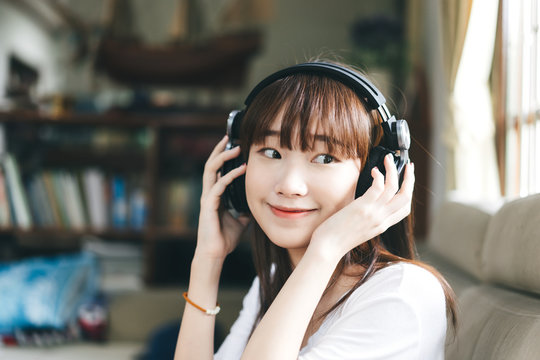 Asian Teenager Woman Listen Music With Headphone Stay At Home.
