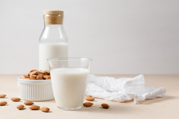 Almond milk in a glass and a glass bottle