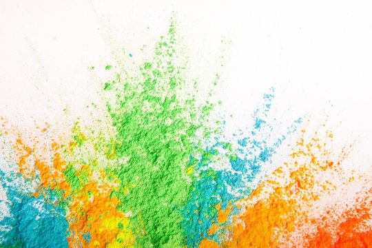 Colorful powder explosion. Abstract bright color dust particles