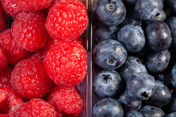 fresh raspberries and blueberries. Close-up view from above