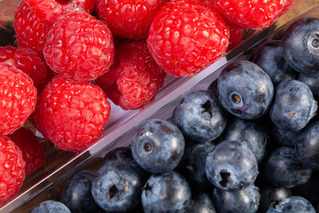 fresh raspberries and blueberries. Close-up view from above