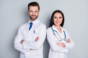 Photo of handsome doc guy lady patient consultation virology clinic stand back-to-back toothy...