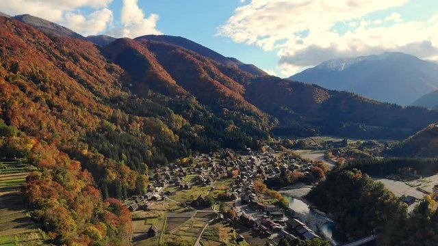 Drone shot of Aerial view over historical village Shirakawa-go village in the autumn during sunset,  Shirakawa-go is one of Japan's UNESCO World Heritage Sites. The traditionally thatched houses.