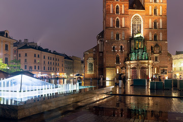 Fototapeta na wymiar Rainy evening market square Krakow with church and fountain, Poland